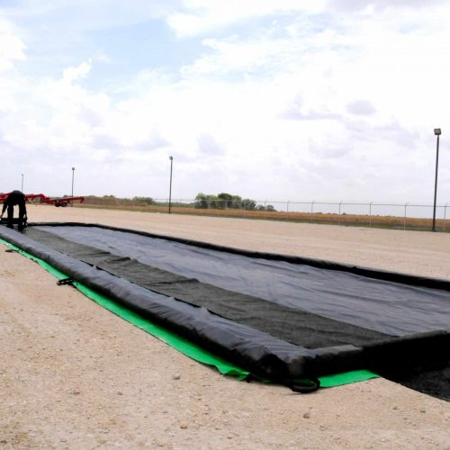 Track belts protect spill containment berms from day-to-day abuse.